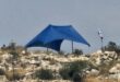 مستوطنون ينصبون خيمة على أراضي قرية دير أبو مشعل شمال غرب رام الله